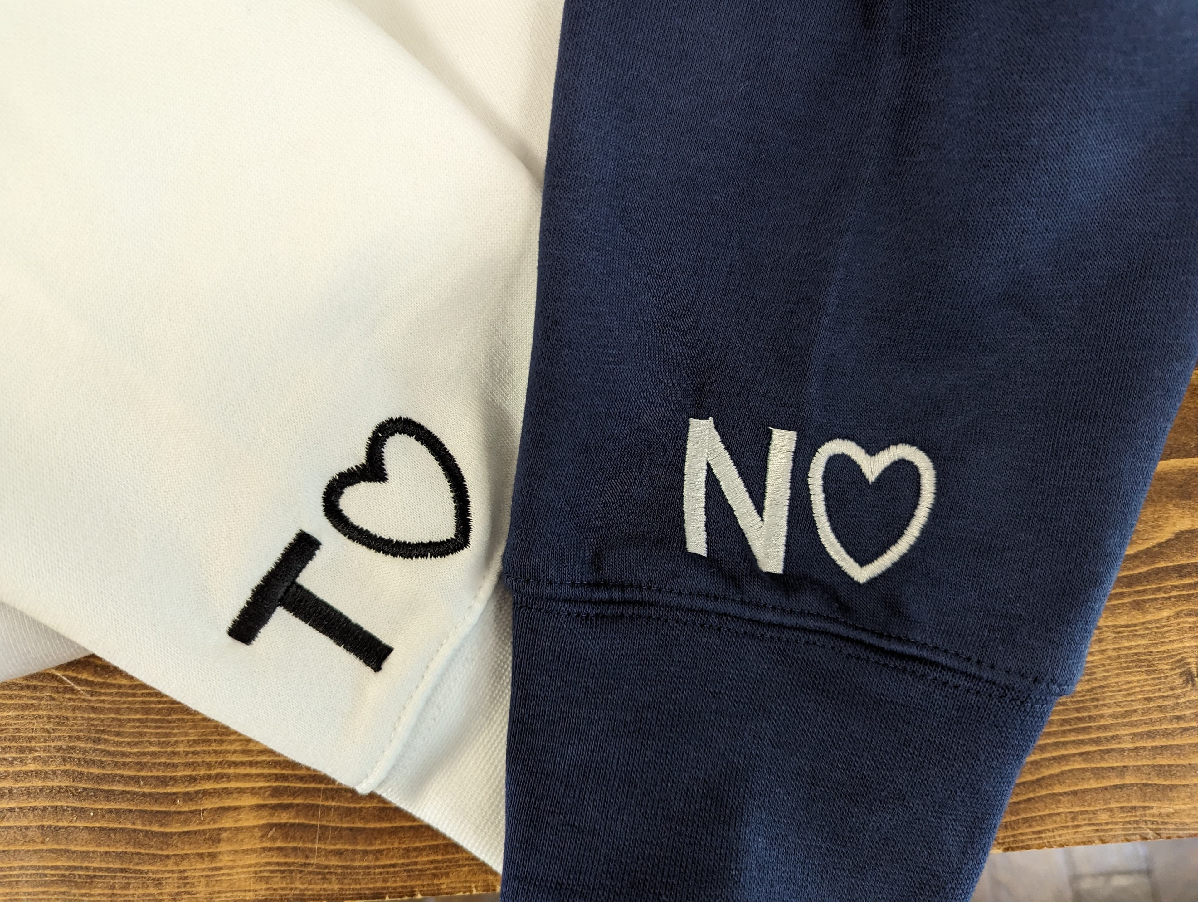 Small embroidered lettering on sleeve cuffs